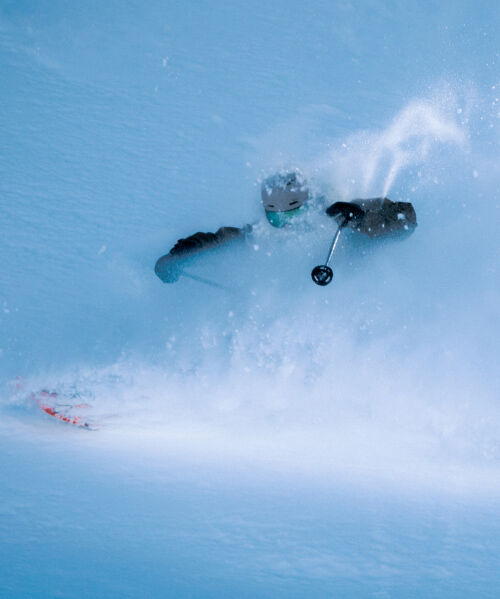 Skier going down a snowy mountain representing the all mountain riding style