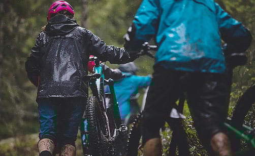 three riders in the rain