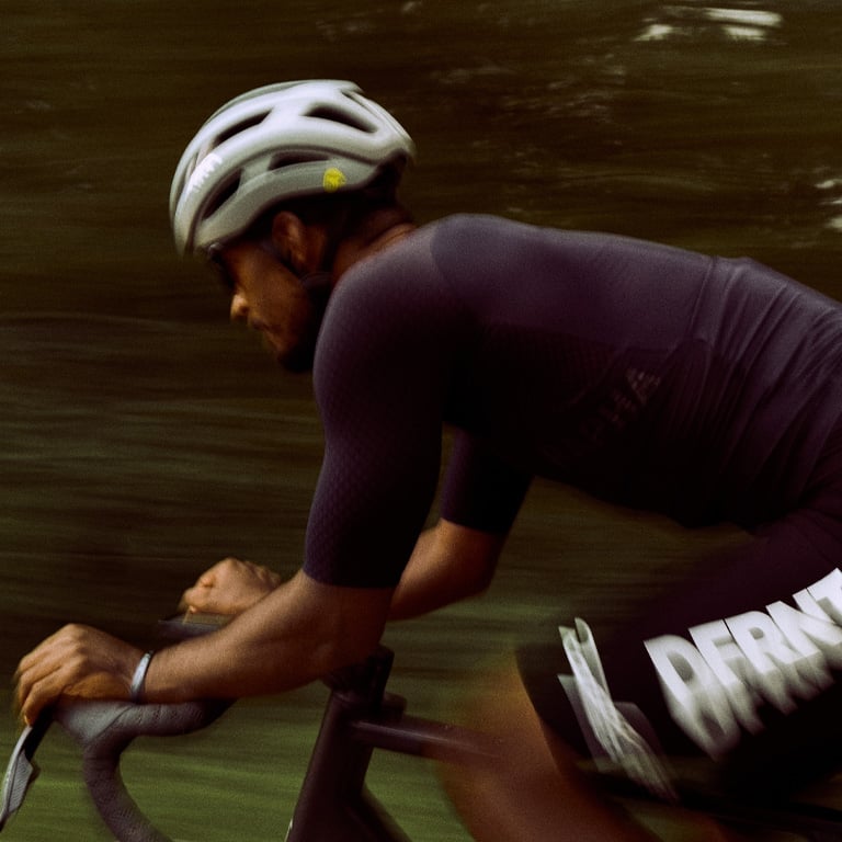 Giro bike rider racing with the Aries Spherical helmet